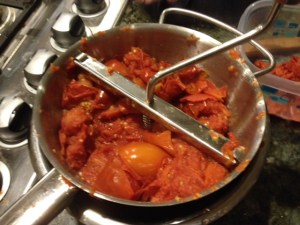 Scoop out the tomatoes from the boiling water into a colander to drain before you begin the milling process. Secure the food mill over a bowl with a proper fit, the mill should sit right into the bowl opening which is about the same size. Place about 5 tomatoes in the food mill and begin milling by turning the handle. The juices from this process will go right into the bowl. That is your fresh homemade tomato sauce!